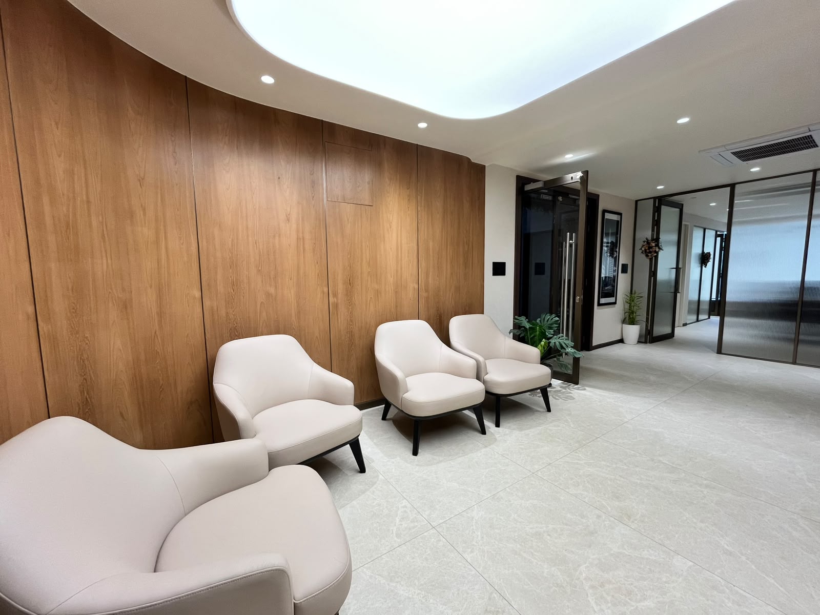 Apartment lobby and reception area with lounge seating and wood panelling
